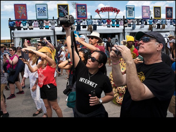 Jazz Fest crowds photographing the Monogram Hunters with Creole Hunters Big Chief Jermaine Bossier in the back ground during day 3. [Photo by Ryan Hodgson-Rigsbee]