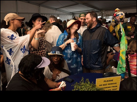 Stephen Schwarz talks with friends at the WWOZ Hospitality Tent during Jazz Fest 2016 Day 6. Schwartz has been coming to Jazz Fest since 1996 and starting bringing the chicken flag in 1998, but this was his first year with a Brass Pass. [Photo by ...