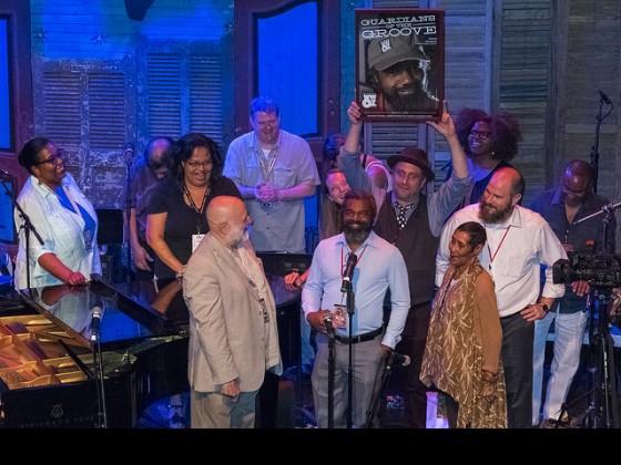 Dwayne Breashears is honored as a WWOZ Guardian of the Groove onstage at Piano Night 2016. Photo by Marc PoKempner.