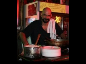 Martin Krusche cooking curry at Saturn Bar. Photo courtesy of Martin.