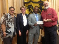 WWOZ's Arthur Cohen (right) and Deb Harkins (second from left) accept the check from Entergy's Customer Service Specialist II and Low Income Champion Demetric Mercadel and Entergy New Orleans President & CEO Charles Rice